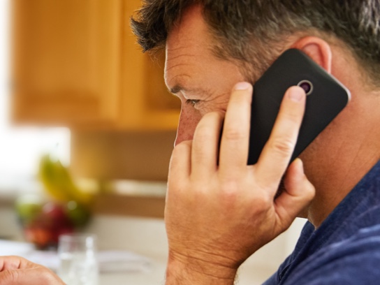 Man holding cell phone to ear.